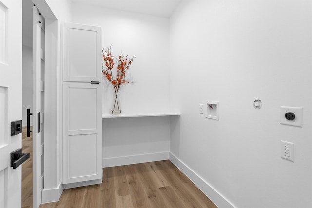 4021 King St, Houston, TX 77026 - laundry room featuring wood finished floors, electric dryer hookup, baseboards, washer hookup, and cabinet space