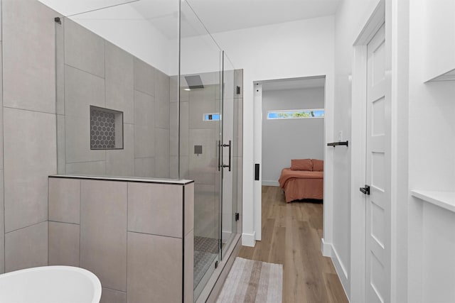4021 King St, Houston, TX 77026 - bathroom featuring a shower stall, wood finished floors, a soaking tub, and connected bathroom