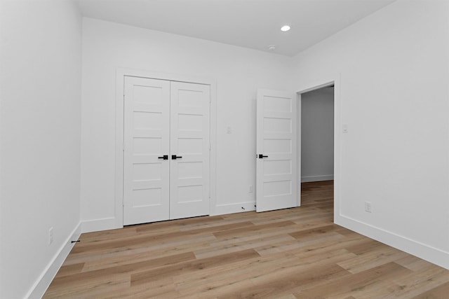 4021 King St, Houston, TX 77026 - unfurnished bedroom with light wood-style floors, baseboards, a closet, and recessed lighting