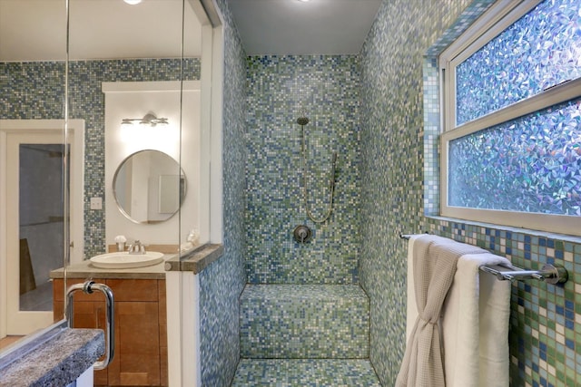 924 E 27th St, Houston, TX 77009 - full bath with a tile shower, vanity, and tile walls