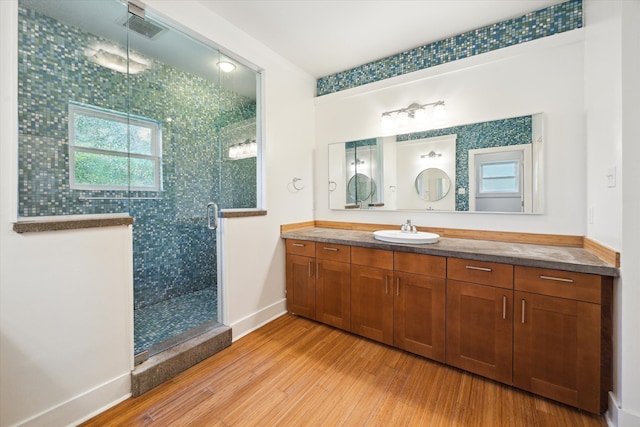 924 E 27th St, Houston, TX 77009 - full bath with wood finished floors, a stall shower, vanity, and baseboards