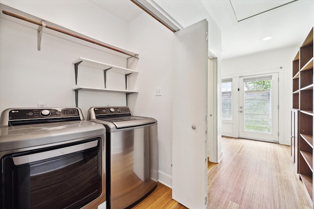 924 E 27th St, Houston, TX 77009 - laundry room featuring washer and dryer, light wood-type flooring, and baseboards