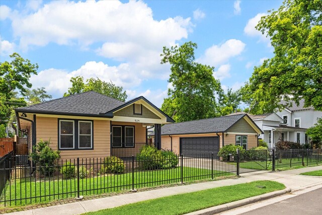 924 E 27th St, Houston, TX 77009 - bungalow with an attached garage, driveway, covered porch, and roof with shingles