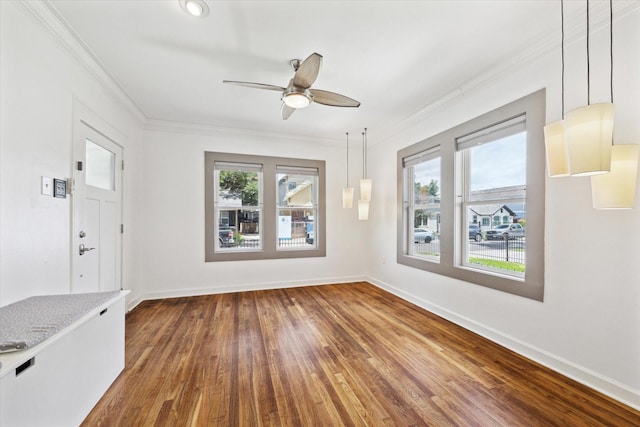 924 E 27th St, Houston, TX 77009 - unfurnished dining area featuring ornamental molding, ceiling fan, hardwood / wood-style floors, and baseboards