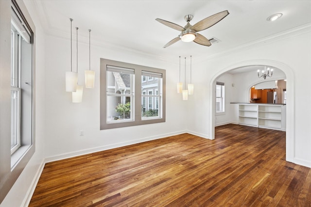 924 E 27th St, Houston, TX 77009 - unfurnished living room featuring wood finished floors, arched walkways, ornamental molding, a ceiling fan, and baseboards