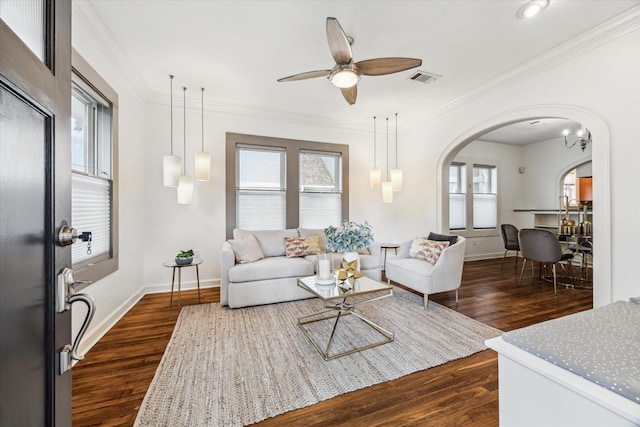 924 E 27th St, Houston, TX 77009 - living area with arched walkways, dark wood-style floors, crown molding, baseboards, and ceiling fan