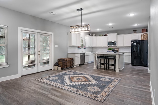 8729 Nathan Dr, Waller, TX 77484 - kitchen featuring appliances with stainless steel finishes, decorative backsplash, healthy amount of natural light, and recessed lighting