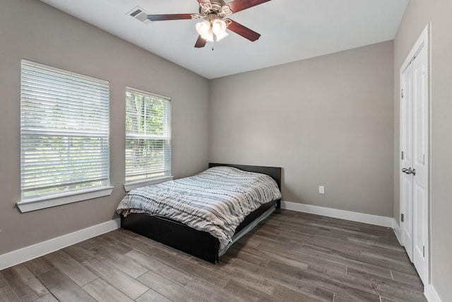 8729 Nathan Dr, Waller, TX 77484 - bedroom featuring baseboards, wood finished floors, and a ceiling fan