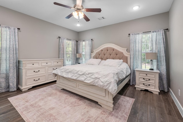 8729 Nathan Dr, Waller, TX 77484 - bedroom featuring dark wood-style flooring, multiple windows, baseboards, a ceiling fan, and recessed lighting