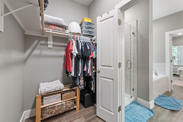 8729 Nathan Dr, Waller, TX 77484 - walk in closet featuring wood finished floors