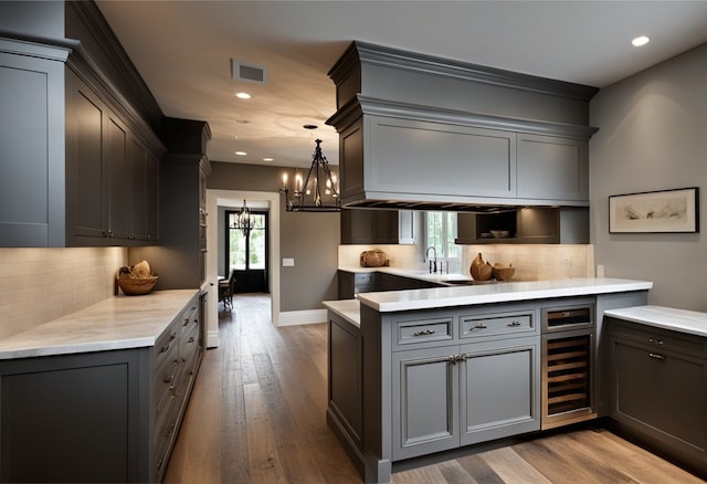 5211 Olympia Fields Ln, Houston, TX 77069 - kitchen featuring wine cooler, a chandelier, recessed lighting, gray cabinetry, and dark wood-style floors