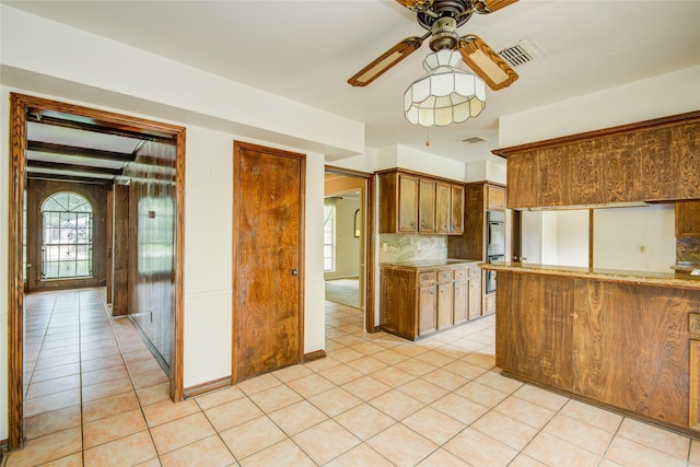 5211 Olympia Fields Ln, Houston, TX 77069 - kitchen with ceiling fan, decorative backsplash, light tile patterned floors, and double oven