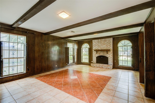 5211 Olympia Fields Ln, Houston, TX 77069 - unfurnished living room with beam ceiling, light tile patterned floors, wooden walls, and a brick fireplace