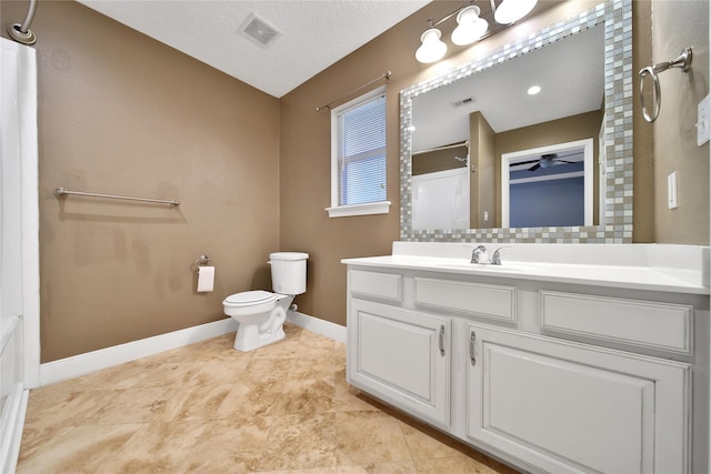 full bathroom featuring baseboards, toilet, vanity, a shower, and tasteful backsplash