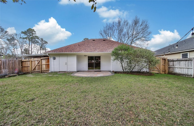 back of property featuring a gate, a patio area, and a shingled roof