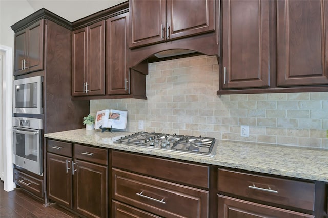 16819 Big Reed Dr, Humble, TX 77346 - kitchen with appliances with stainless steel finishes, light stone counters, and backsplash