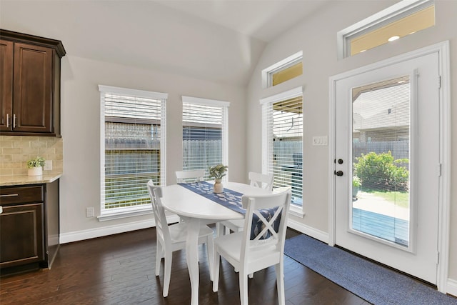 16819 Big Reed Dr, Humble, TX 77346 - dining space featuring vaulted ceiling, dark wood-style floors, and baseboards