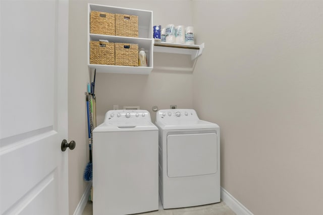 16819 Big Reed Dr, Humble, TX 77346 - laundry room with washing machine and clothes dryer and baseboards
