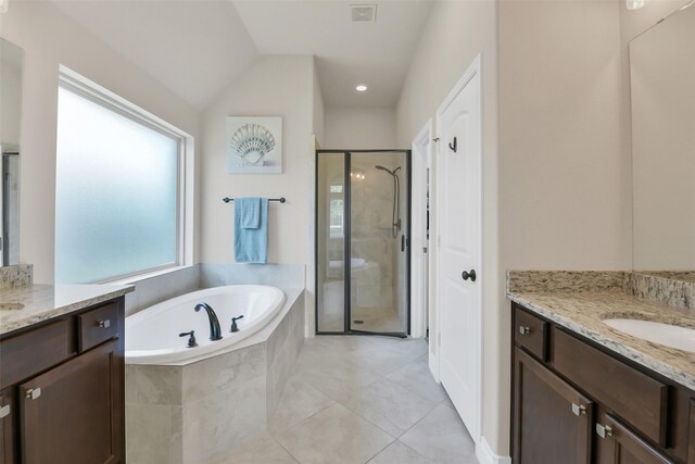 16819 Big Reed Dr, Humble, TX 77346 - full bathroom with a stall shower, a garden tub, two vanities, and tile patterned flooring