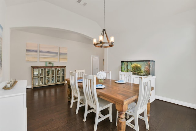 16819 Big Reed Dr, Humble, TX 77346 - dining room featuring a chandelier, wood finished floors, lofted ceiling, baseboards, and arched walkways