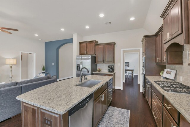 16819 Big Reed Dr, Humble, TX 77346 - kitchen featuring a sink, stainless steel appliances, open floor plan, a ceiling fan, and a center island with sink