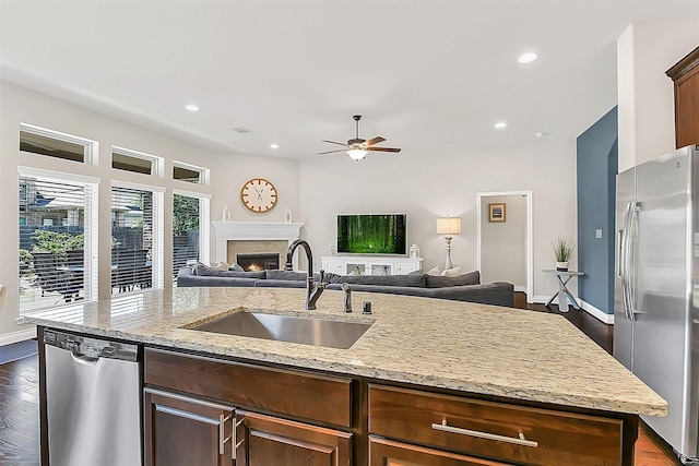 16819 Big Reed Dr, Humble, TX 77346 - kitchen with appliances with stainless steel finishes, a sink, an island with sink, open floor plan, and recessed lighting