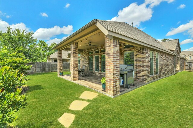 16819 Big Reed Dr, Humble, TX 77346 - back of house with brick siding, ceiling fan, roof with shingles, and a patio