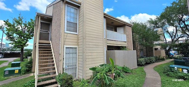 10211 Sugar Branch Dr Unit 444, Houston, TX 77036 - view of side of property featuring stairs and fence