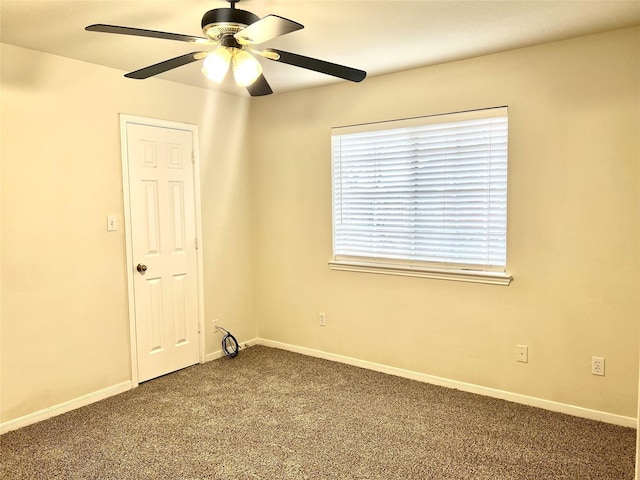 unfurnished room featuring dark carpet, a ceiling fan, and baseboards