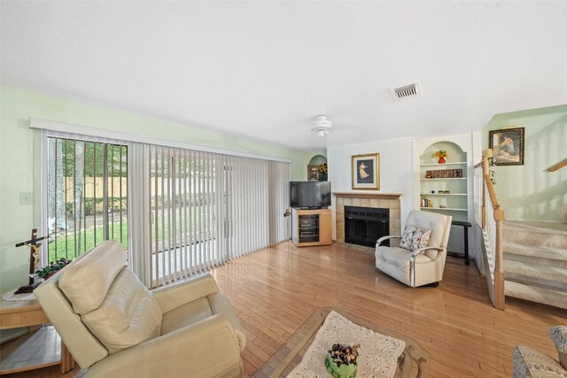 14911 Wunderlich Dr Unit 1501, Houston, TX 77069 - living area featuring light wood finished floors, stairway, and a tile fireplace
