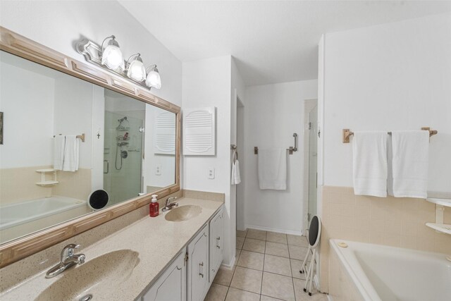 14911 Wunderlich Dr Unit 1501, Houston, TX 77069 - bathroom with tile patterned floors, a stall shower, a garden tub, double vanity, and baseboards