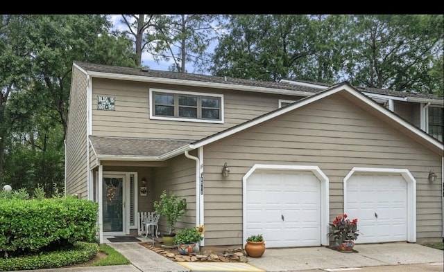 14911 Wunderlich Dr Unit 1501, Houston, TX 77069 - view of front of property featuring concrete driveway, a shingled roof, and an attached garage