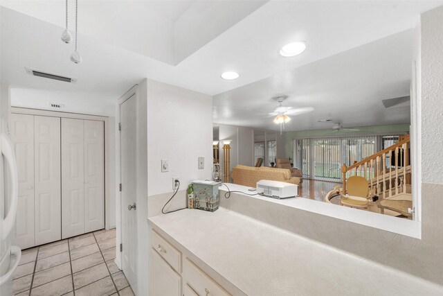14911 Wunderlich Dr Unit 1501, Houston, TX 77069 - kitchen featuring light tile patterned floors, ceiling fan, light countertops, and white cabinetry