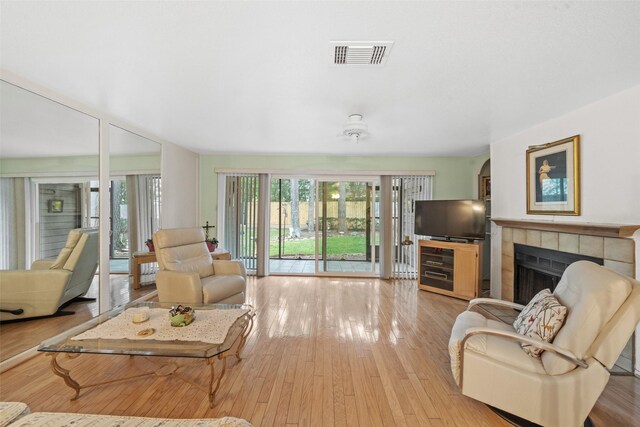 14911 Wunderlich Dr Unit 1501, Houston, TX 77069 - living area featuring a tile fireplace and wood-type flooring