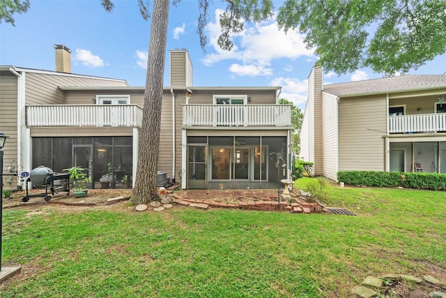 14911 Wunderlich Dr Unit 1501, Houston, TX 77069 - rear view of property with a balcony, a sunroom, and a lawn