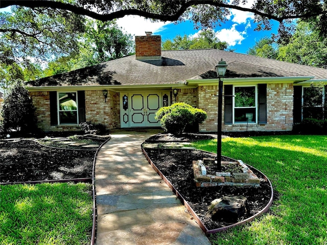3007 Broadmoor Dr, Sugar Land, TX 77478 - ranch-style home with a chimney, brick siding, a front lawn, and a shingled roof