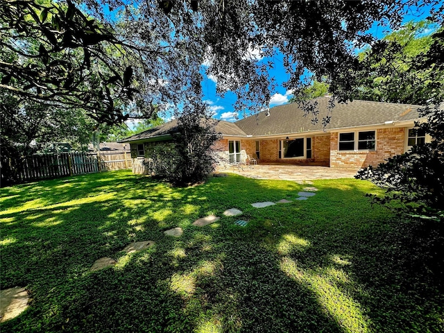 3007 Broadmoor Dr, Sugar Land, TX 77478 - rear view of house with a patio, brick siding, and a shingled roof