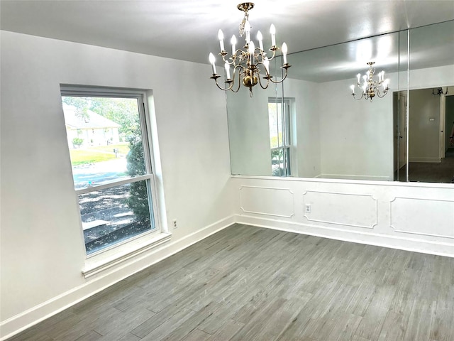3007 Broadmoor Dr, Sugar Land, TX 77478 - unfurnished room featuring a chandelier, wood finished floors, and baseboards