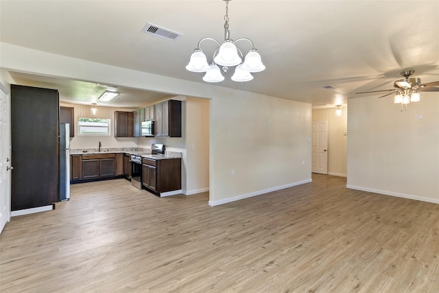 401 S Fig St, Sweeny, TX 77480 - kitchen featuring appliances with stainless steel finishes, open floor plan, and light wood finished floors