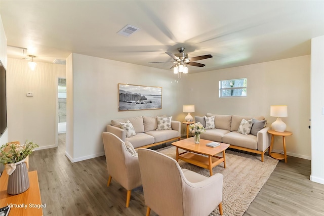 401 S Fig St, Sweeny, TX 77480 - living area featuring baseboards, wood finished floors, and ceiling fan