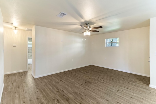 401 S Fig St, Sweeny, TX 77480 - spare room with wood finished floors, a ceiling fan, and baseboards