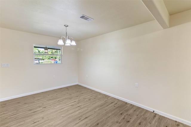 401 S Fig St, Sweeny, TX 77480 - unfurnished room featuring light wood-style floors, a chandelier, and baseboards