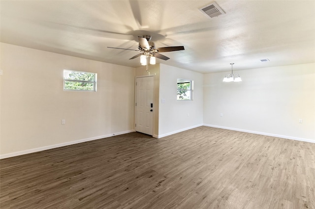 401 S Fig St, Sweeny, TX 77480 - unfurnished room featuring a chandelier, dark wood finished floors, a ceiling fan, and baseboards