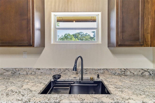 401 S Fig St, Sweeny, TX 77480 - kitchen view of a sink, dark brown cabinets, and light stone countertops