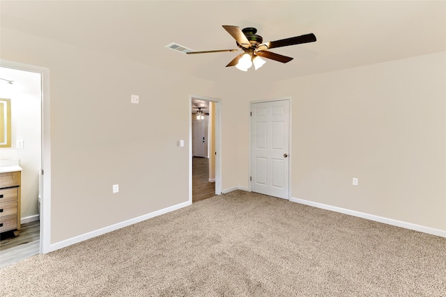 401 S Fig St, Sweeny, TX 77480 - unfurnished bedroom featuring light carpet, baseboards, ensuite bath, and a ceiling fan