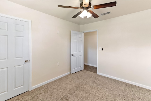 401 S Fig St, Sweeny, TX 77480 - unfurnished bedroom featuring light colored carpet, baseboards, and a ceiling fan
