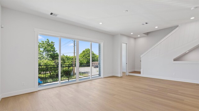 3605 Mount Pleasant St, Houston, TX 77021 - unfurnished living room with light wood-style floors, stairs, recessed lighting, and baseboards