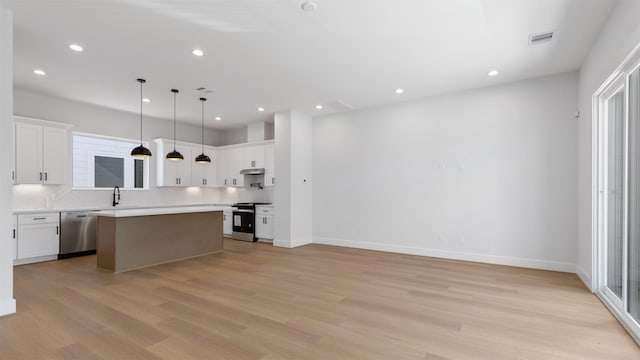 3605 Mount Pleasant St, Houston, TX 77021 - kitchen featuring stainless steel dishwasher, electric range, a kitchen island, light wood-type flooring, and recessed lighting