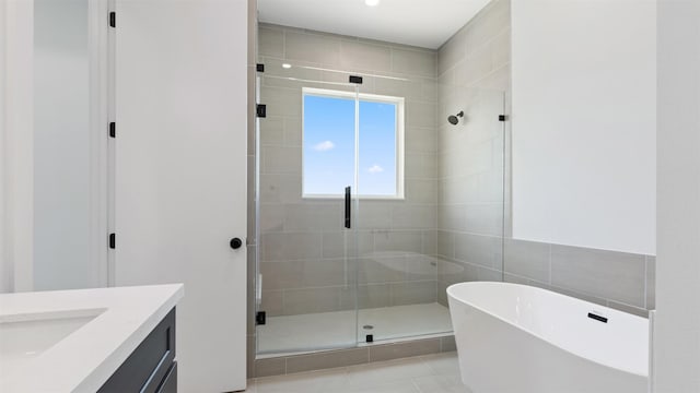 3605 Mount Pleasant St, Houston, TX 77021 - bathroom featuring a stall shower, a freestanding bath, vanity, and tile patterned flooring