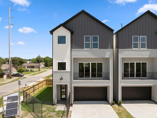 3605 Mount Pleasant St, Houston, TX 77021 - view of front facade with board and batten siding, a garage, and concrete driveway